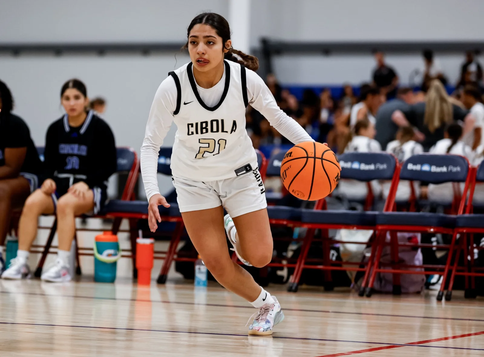 Girls basketball player dribbling in competition